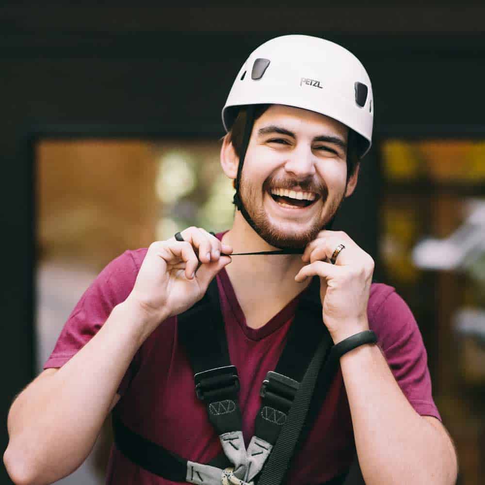 Smiling zip-liner preparing for Forest Flight Tour